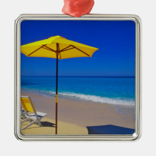 Yellow beach umbrella and chairs on pristine metal ornament