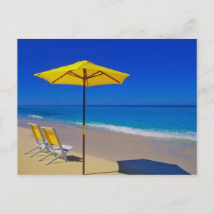 Yellow beach umbrella and chairs on pristine postcard