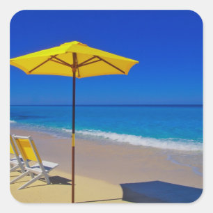 Yellow beach umbrella and chairs on pristine square sticker