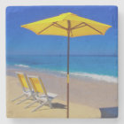 Yellow beach umbrella and chairs on pristine