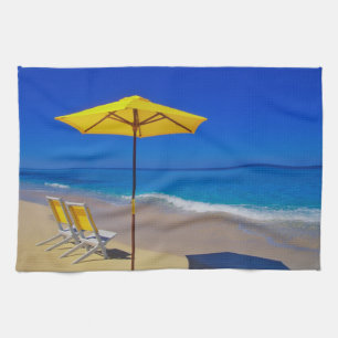 Yellow beach umbrella and chairs on pristine tea towel