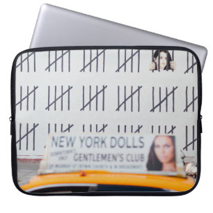 YELLOW CAB IN FRONT OF WHITE PAINTED WALL LAPTOP SLEEVE