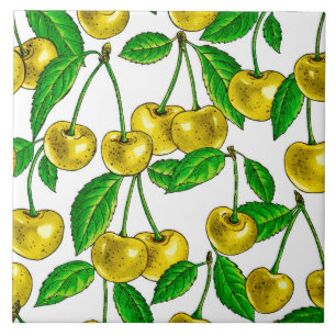 Yellow cherries on white ceramic tile