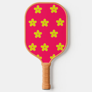 Yellow floral pattern on pink pickleball paddle
