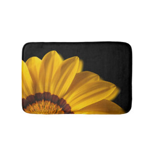 Yellow flower on black background bath mat