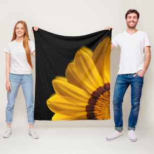 Yellow flower on black background fleece blanket