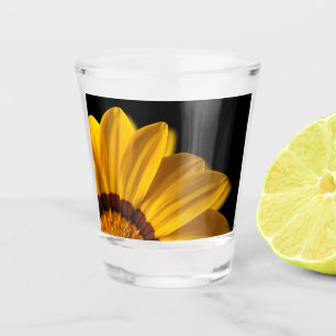 Yellow flower on black background shot glass