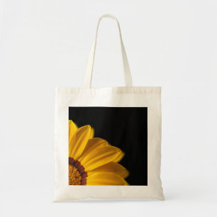 Yellow flower on black background tote bag