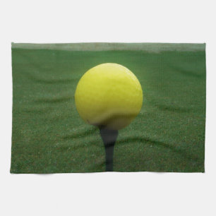 Yellow Golf Ball on a mountain golf course Tea Towel