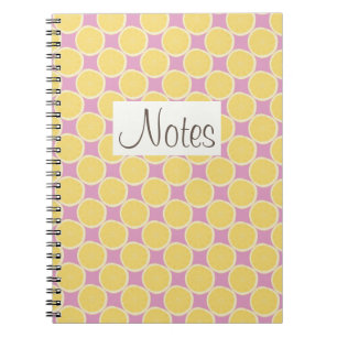 Yellow lemon slices on bright pink notebook