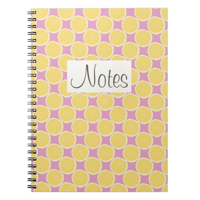 Yellow lemon slices on bright pink notebook (Front)