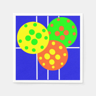 Yellow, orange, & green pickleballs on blue court napkin