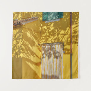 Yellow painted concreted building tapestry