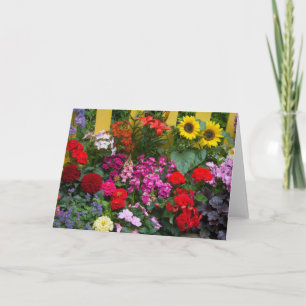 Yellow picket fence with flower garden in card