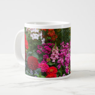 Yellow picket fence with flower garden in large coffee mug