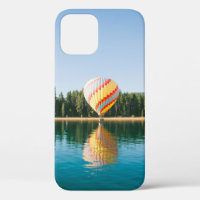 Yellow, red, and blue hot air balloon near trees a
