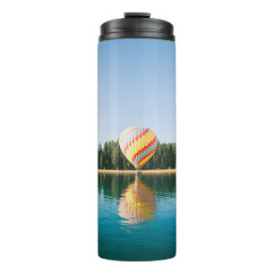 Yellow, red, and blue hot air balloon near trees a thermal tumbler