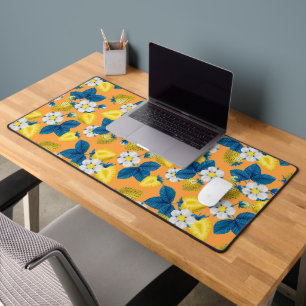 Yellow strawberries on orange desk mat