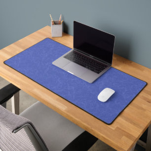 Yellow textured surface with swirling pattern desk mat