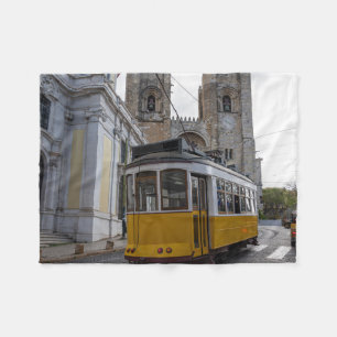 Yellow tram on Lisbon Cathedral in Portugal Fleece Blanket