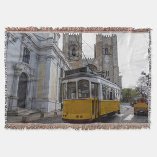 Yellow tram on Lisbon Cathedral in Portugal Throw Blanket