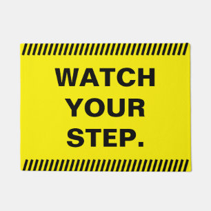 Yellow watch your step doormat
