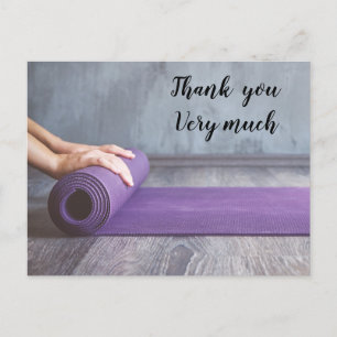 Yoga woman rolls yoga mat postcard
