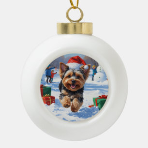 Yorkipoo Running in Snow with Christmas Hat Ceramic Ball Christmas Ornament
