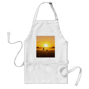 Young boy running with dog at sunset standard apron