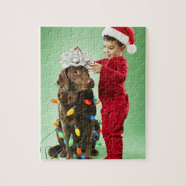 Young boy wrapping Christmas lights around a dog Jigsaw Puzzle (Vertical)