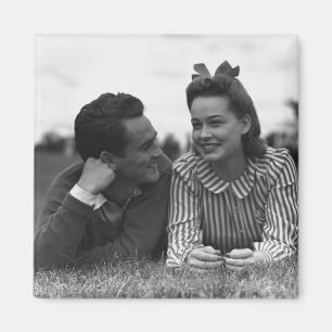 Young couple lying on grass magnet