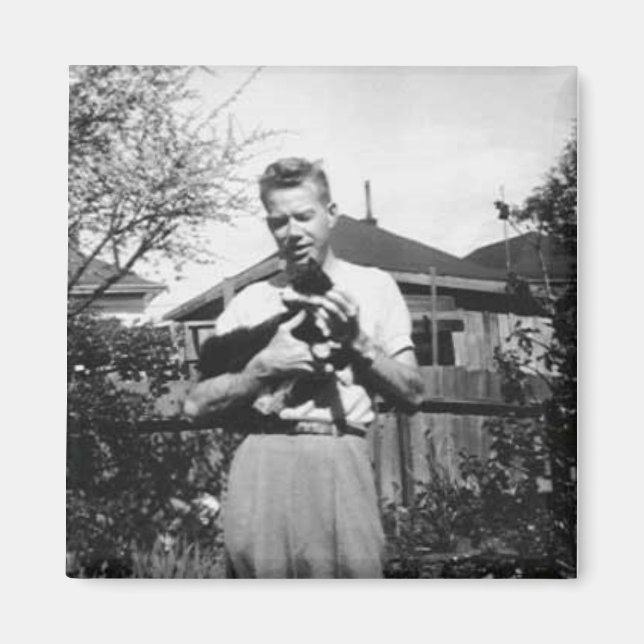 Young man holding a cat magnet (Front)