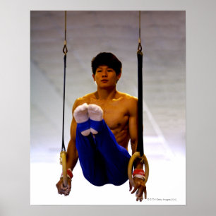 Young man practicing gymnastic rings poster