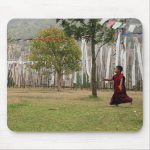Young monk and prayer flags mouse pad