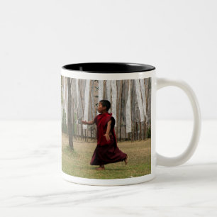 Young monk and prayer flags Two-Tone coffee mug