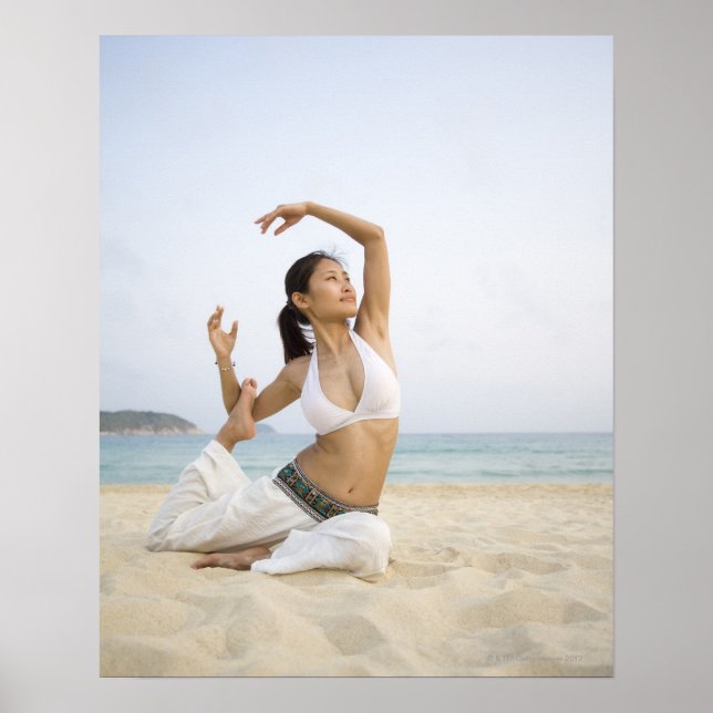 Young woman doing yoga on the beach poster (Front)