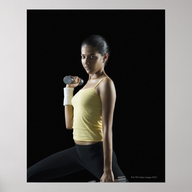Young woman exercising with dumbbells poster (Front)