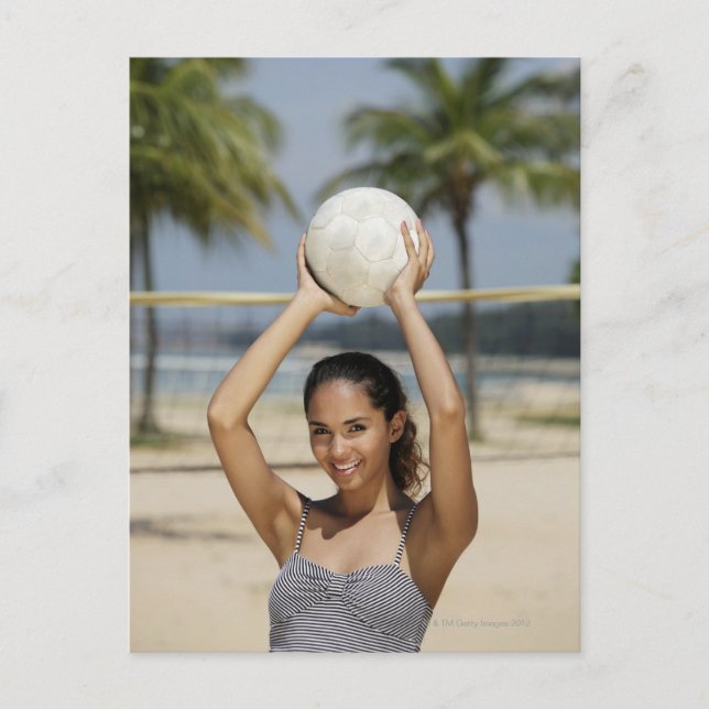 Young woman holding volleyball and smiling at postcard (Front)