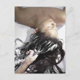 Young woman receiving hair treatment postcard