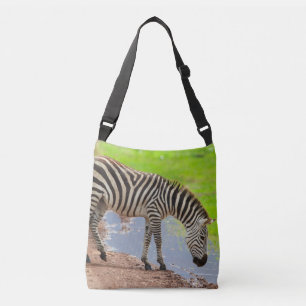 Zebra drinking water from the river. Serengeti Crossbody Bag