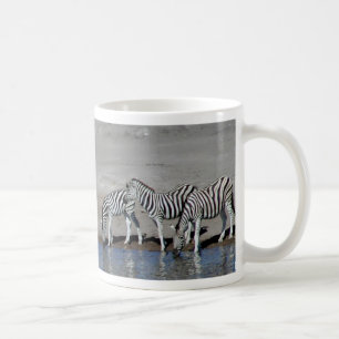 Zebras and giraffe at the local watering hole Mug